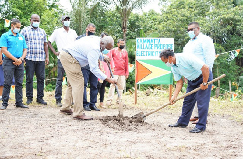 Prime Minister, Brigadier (Ret’d) Mark Phillips, and Toshao of Kamwatta village, Maurice Henry, turn the sod, as part of a ceremonial exercise on Tuesday, to mark the commencement of work at the site designated for a new power generation facility. A similar exercise was held at Whitewater village (DPI photo)