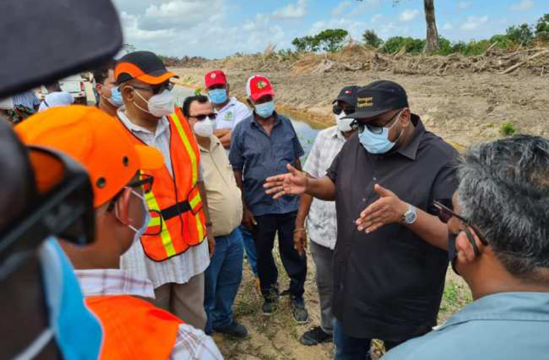 President Dr. Irfaan Ali in discussion with Minister of Public Works Bishop Juan Edghill and engineers during a recent tour of the site for the road that will run from the new Demerara Harbour Bridge to Parika
