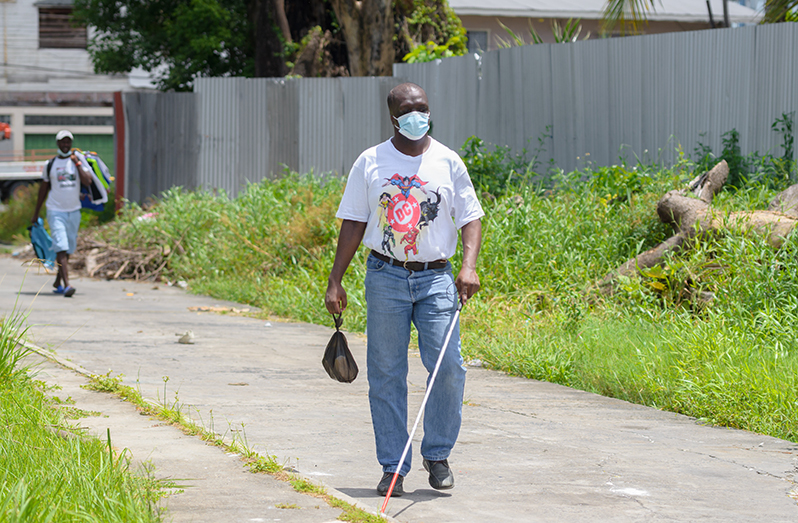 A member of the Guyana Society for the Blind making his way to the organisation’s High Street, Headquarters (Delano Williams photo)