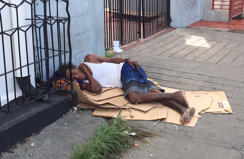 A destitute citizen sleeping on the Bourda Market pavement.
(Photo by Francis Q. Farrier)