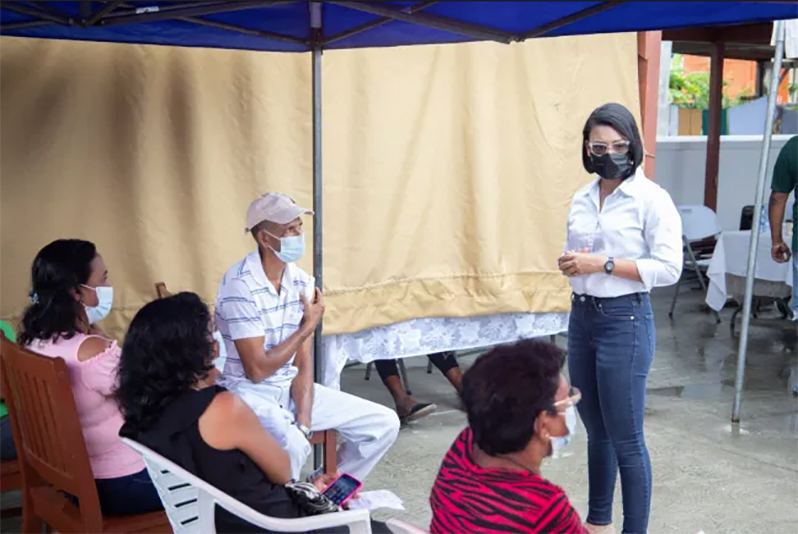 Minister within the Ministry of Housing, Susan Rodrigues, interacts with residents of Block 8 Mon Repos during a vaccination exercise in the community on Saturday