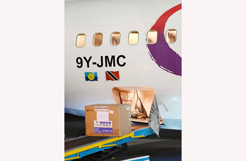 A batch of the Sinopharm vaccine being transported off the plane at the Cheddi Jagan International Airport