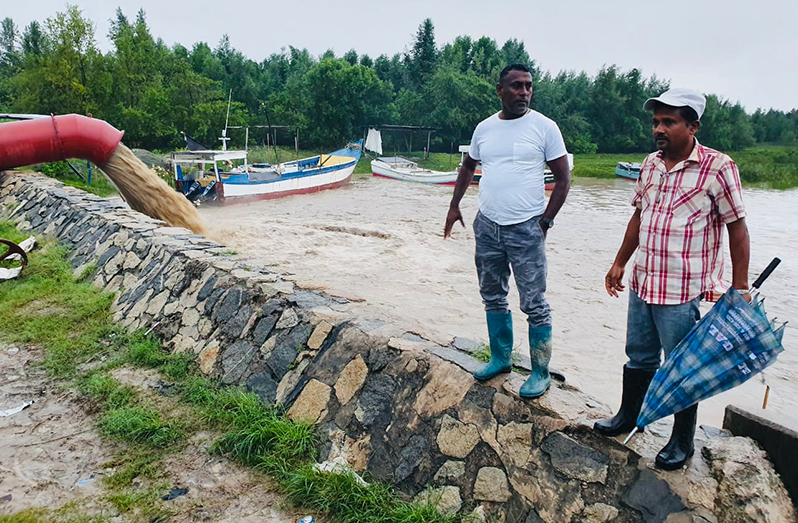 Regional Vice-Chairman Humace Oodit (right) and an overseer inspecting the pump at Taymonth Manor