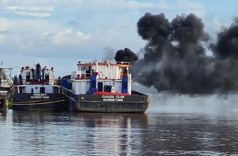 Smoke engulfs the Canada Club vessel during the explosion at the Friendship wharf, East Bank Demerara, on Saturday