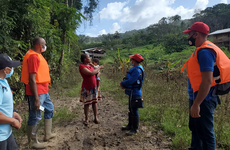 Amerindian Affairs, Minister Pauline Sukhai interacting with a resident who had lost her crops to the floods (Ministry of Amerindian Affairs photo)