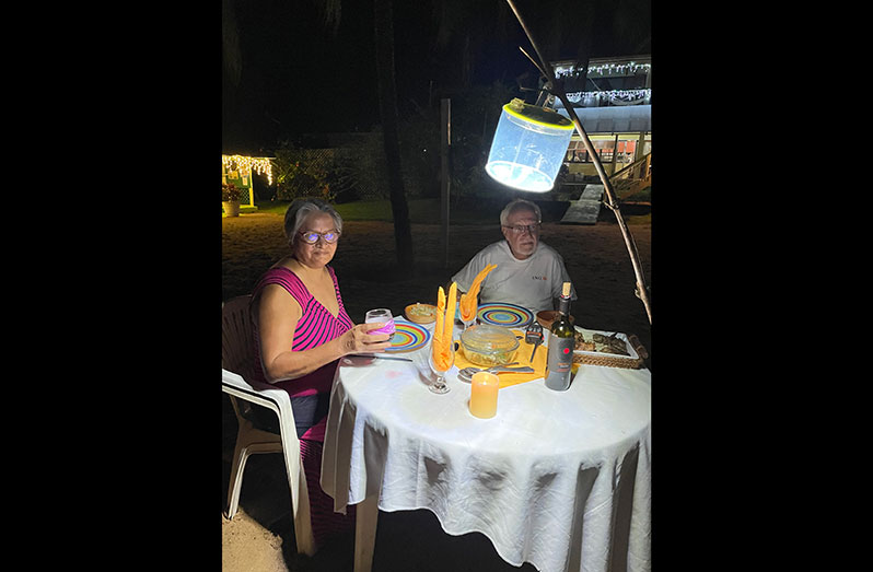 Gem Madhoo and her husband Kit Nascimento enjoy a meal together at their Essequibo tourist resort