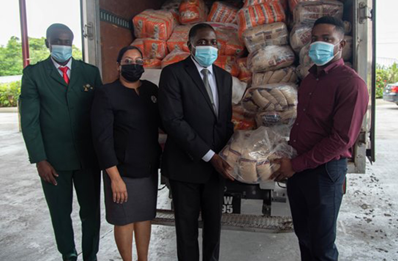 President of the Guyana Conference of Seventh Day Adventist, Pastor Exton Clarke, hands over some of the relief items to CDC’s Public Relations Officer, Patrice Wishart, and Pastor Andrew Chichester and Treasurer, Rovena Harrinauth look on (DPI photo)