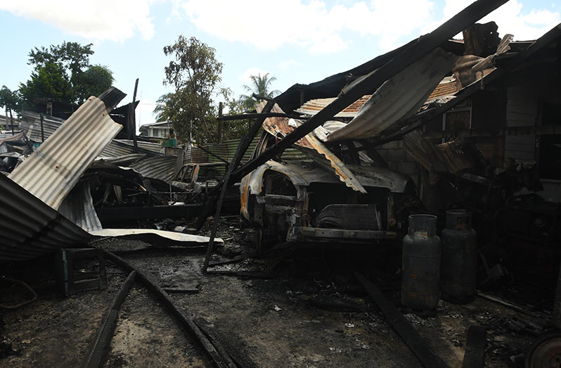 The charred remains of the mechanic’s residence in the Go Slow squatting area (Adrian Narine photo)