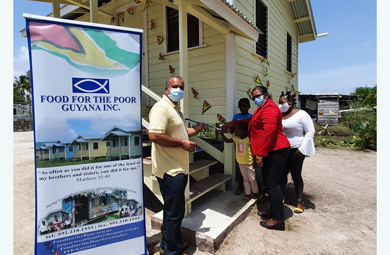 Chief Executive Officer of the Food for the Poor, Kent Vincent is joined by Regional Chairperson, Vilma De Silva, as he hands over a house to a family at Queenstown