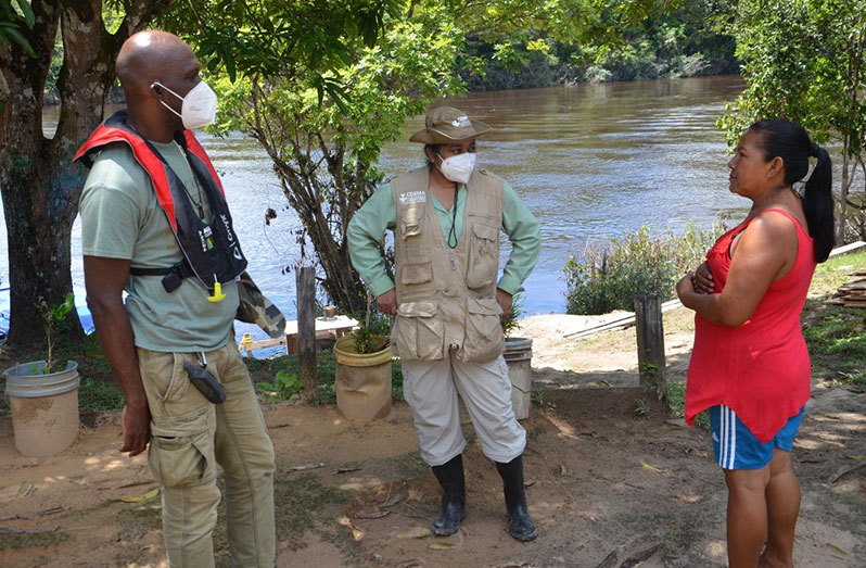 CDC Director-General Lieutenant-Colonel Kester Craig (left) and CDEMA Preparedness Response Manager Joanne Persad (centre), speak with a resident during an observation mission in Region Seven on Saturday