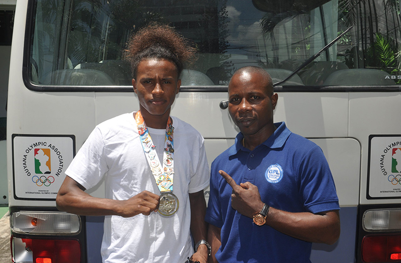 FLASHBACK! Keevin Allicock (L) and his coach Sebert Blake showing off his silver medal won at the 2017 Youth Commonwealth Games in The Bahamas.