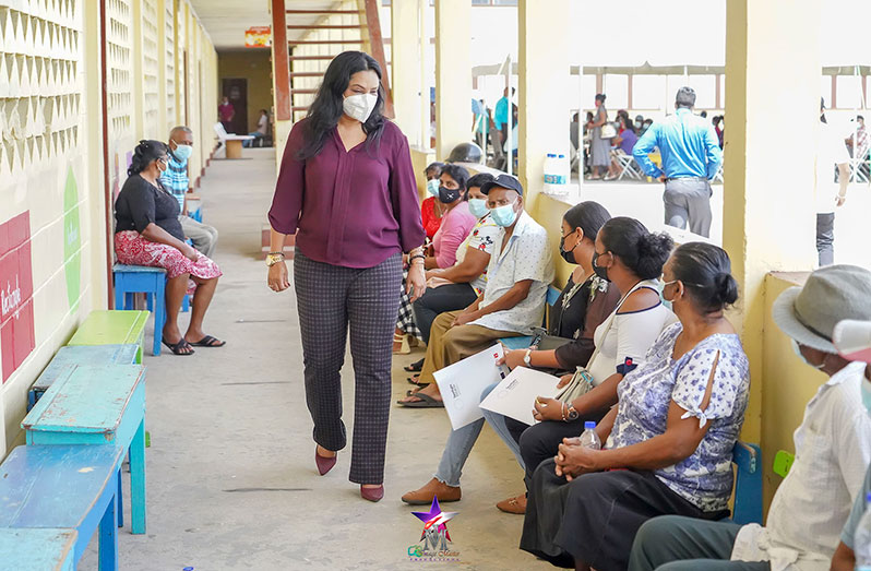 Minister of Human Services and Social Security, Dr. Vindhya Persaud, greets residents at the Mon Repos Primary School, during her outreach to the community on Monday