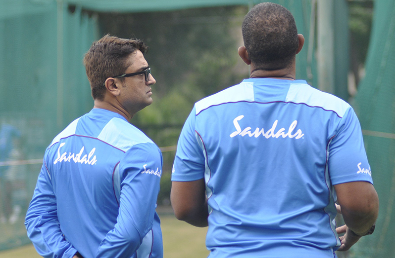 Batting coach, Monty Desai (left) shares a word with head coach, Phil Simmons