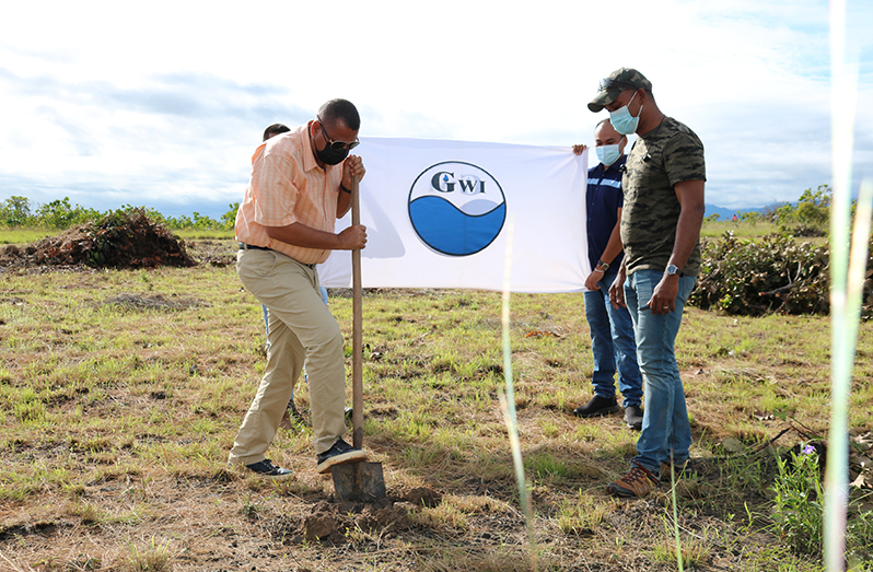 Minister of Housing and Water, Collin Croal, turns the sod for the construction of a new building in Lethem to house the GWI and CH&PA offices, as Director of Hinterland Services at GWI, Ramchand Jailall looks on