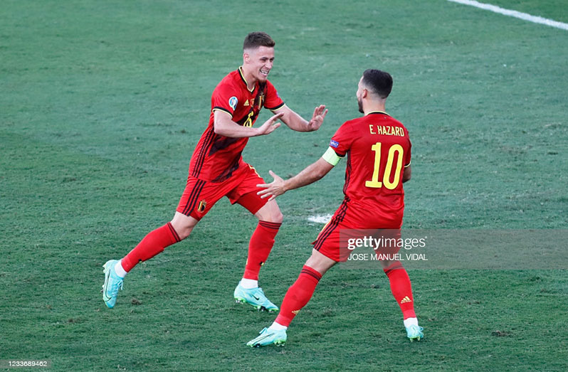 Belgium's midfielder Thorgan Hazard (L) celebrates with Belgium's forward Eden Hazard after scoring the first goal during the UEFA EURO 2020 round of 16 football match between Belgium and Portugal at La Cartuja Stadium in Seville on June 27, 2021. (Photo by Jose Manuel Vidal / POOL / AFP) (Photo by JOSE MANUEL VIDAL/POOL/AFP via Getty Images)