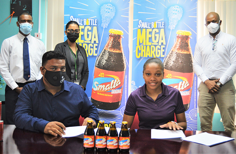 (Back left) Errol Nelson CBL Business Unit head, (back second left) Gabriella Lopes Brand Manager Smalta, (back extreme right) Godfrey Munroe GTTA president. (sitting left) Kelvin Singh CBL Country Manager and Tennis star Chelsea Edghill.