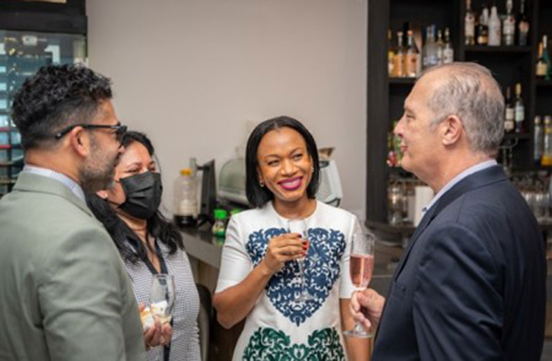 Tourism, Industry and Commerce, Minister Oneidge Walrond shares a light moment with persons at the launch of Restaurant Week on Thursday