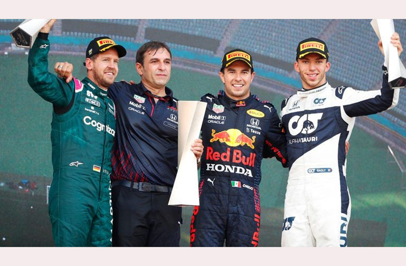 (L-R) Second placed Sebastian Vettel of Germany and Aston Martin F1 Team, Pierre Wache, Chief Engineer of Performance Engineering at Red Bull Racing, race winner Sergio Perez of Mexico and Red Bull Racing and third placed Pierre Gasly of France and Scuderia AlphaTauri