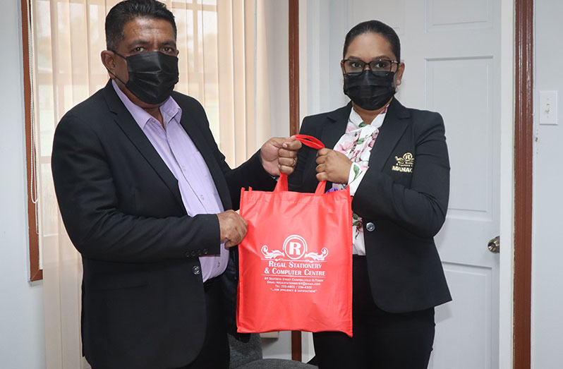 Agriculture Minister, Zulfikar Mustapha, collects one of the hampers from a representative of Regal Stationery and Computer Centre