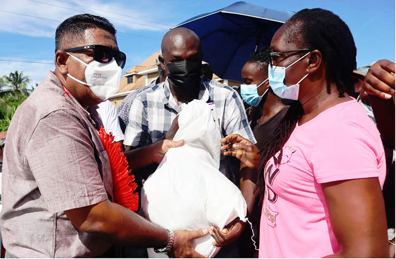 Agriculture Minister Zulfikar Mustapha presents a hamper to a resident