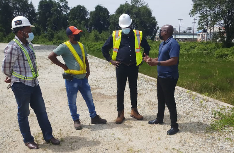 Here, Ninvalle (right) holds discussion with the consultant (second from right) and engineers.