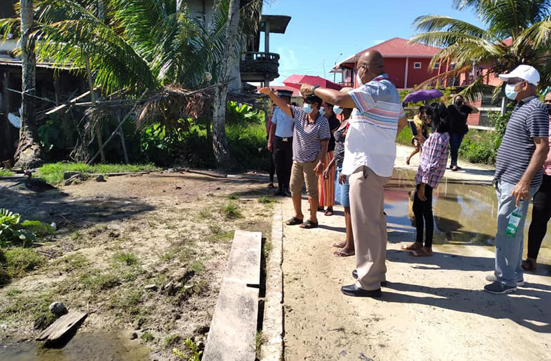 Residents of the Blankenburg community pointing out issues with drainage to Public Works Minister Juan Edghill, during an inspection exercise on Saturday