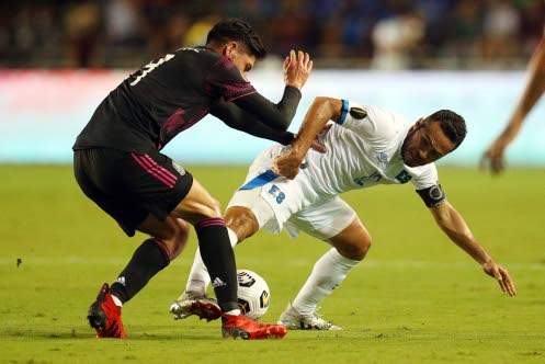 Edson Alvarez (left) of Mexico and Marvin Monterroza of El Salvador battle for the ball at Cotton Bowl in Dallas, Texas, on Sunday. (Photo: AFP)