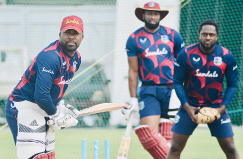 Left-hander Darren Bravo bats in the nets ahead of the first ODI as captain Kieron Pollard (middle) and team psychologist Donald La Guerre look on. (Photo courtesy CWI Media)
