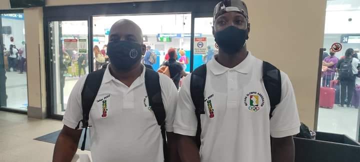 Coach Julian Edmonds and 100m National champion Emanuel Archibald prior to their departure from the Cheddi Jagan International Airport yesterday.