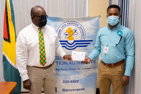 Safety Coordinator, GCAA, Courtney Frank, handed over the donation to Public Information Officer, CDC, Patrice Wishart (DPI photo)