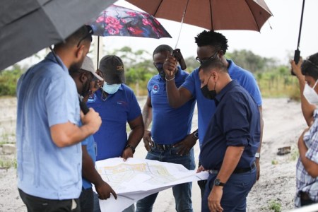 Housing and Water Minister, Collin Croal, and Permanent Secretary, Andre Ally, along with a team of engineers of the Projects Department, at the site earmarked for the houses in Amelia’s Ward Phase Two (DPI photo)