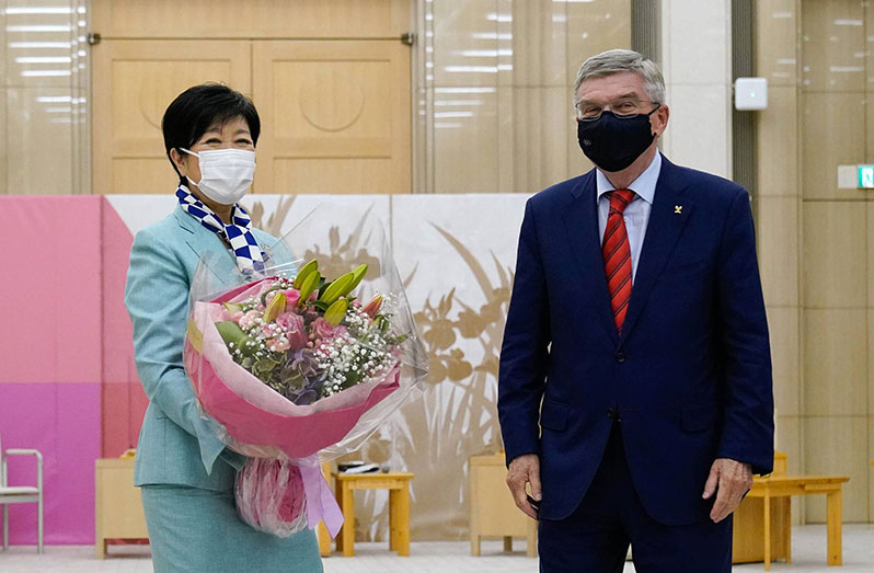 Thomas Bach (right), president of the International Olympic Committee, meets with Tokyo Gov. Yuriko Koike in Tokyo yesterday. | (BLOOMBERG)