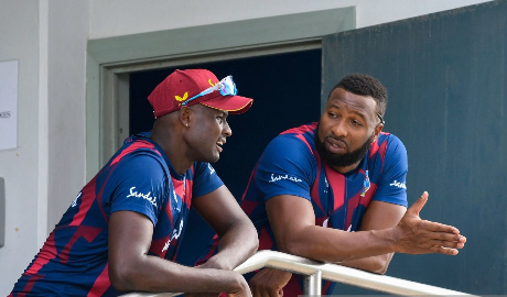 A concerned-looking West Indies captain Kieron Pollard (right) is deep in discussion with senior all-rounder Jason Holder, following the abandonment of the second ODI here yesterday.