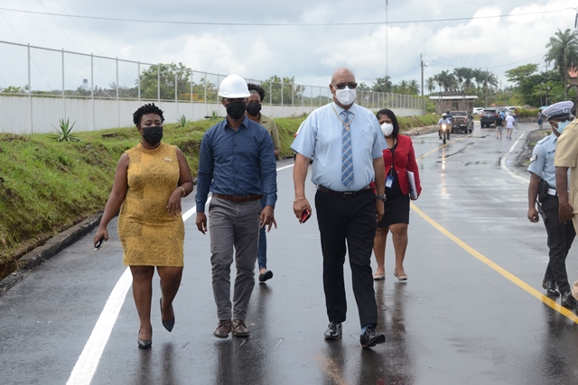 Public Works Minister, Bishop Juan Edghill, Head of the Special Projects Unit, Colin Gittens and Mayor of Linden, Waneka Arrindell walking on the rehabilitated road (DPI photo)