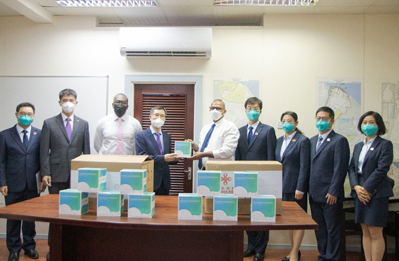 Charge d’ Affaires of the People’s Republic of China’s Embassy, Chen Xilai (fourth left) with Minister of Health, Dr. Frank Anthony (fifth right), at the handing over ceremony of the medical equipment