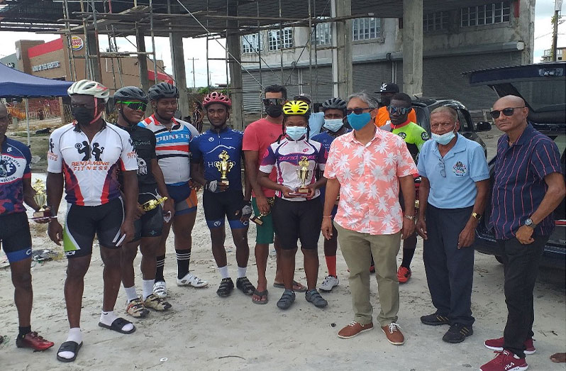 Chief Executive Officer of David Persaud Investments, Christopher Persaud, third from right is flanked by Hassan Mohamed, staff and winners with their trophies and cash prizes.