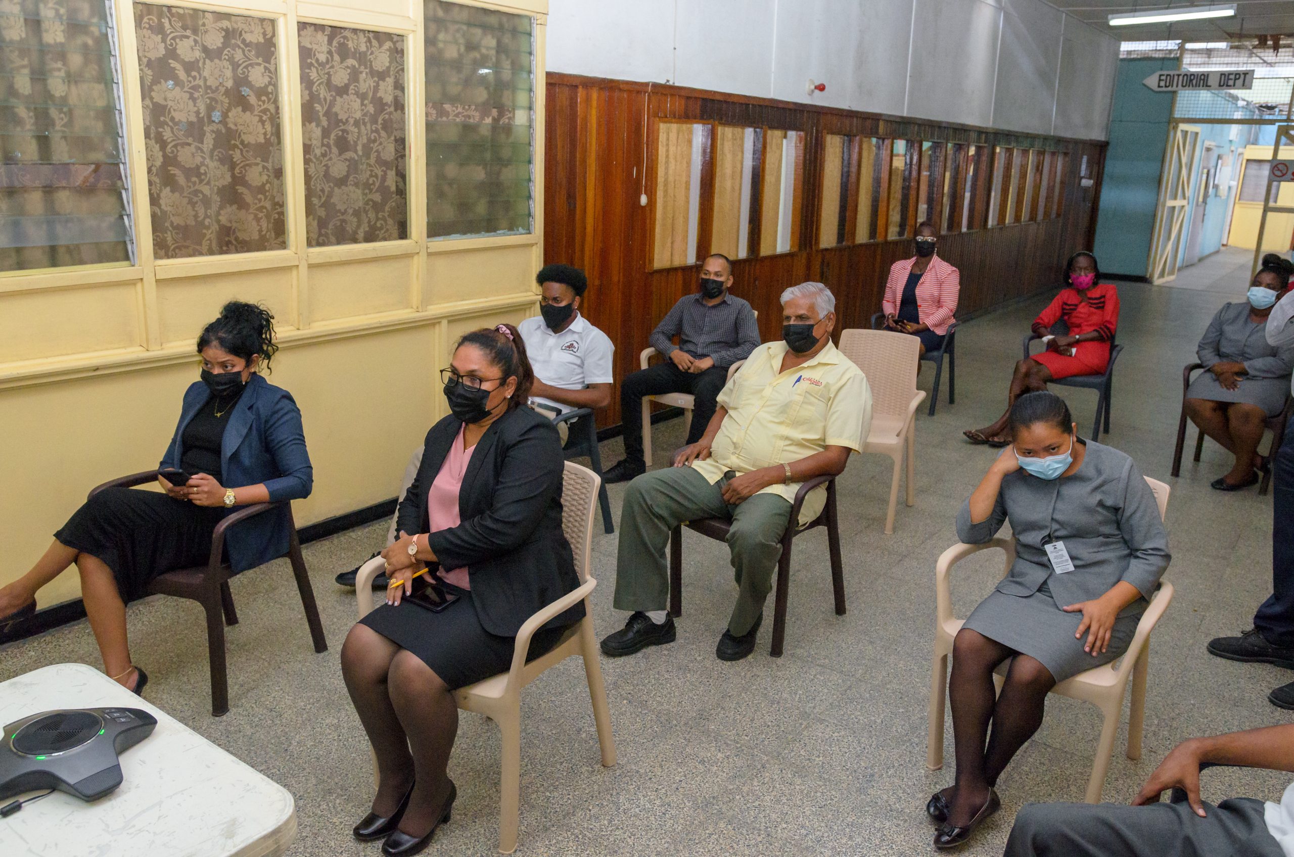 Guyana National Newspapers Limited (GNNL) General Manager, Moshamie Ramotar (right, front row) and some staffers of the newspaper pay keen attention during a virtual health talk on the benefits of COVID-19 vaccine. The talk was delivered by Maternal and Child Health Officer of the Ministry of Health, Dr. Oneka Scott on Thursday (Delano Williams photo)