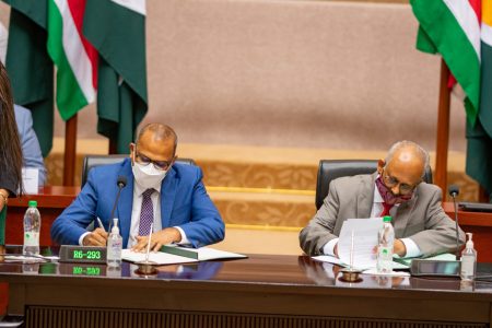 Dr. Frank Anthony, Minister of Health, performing duties as Guyana’s Minister of Foreign Affairs, and Suriname’s Minister of Foreign Affairs, International Business and International Cooperation, Albert Ramdin, inked the agreement on the establishment of services in the field of healthcare (DPI photo)