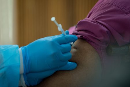 An adult taking the COVID-19 vaccine