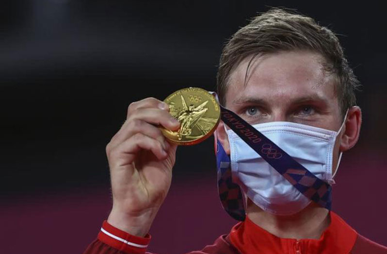 Denmark's Viktor Axelsen celebrates with his gold medal.