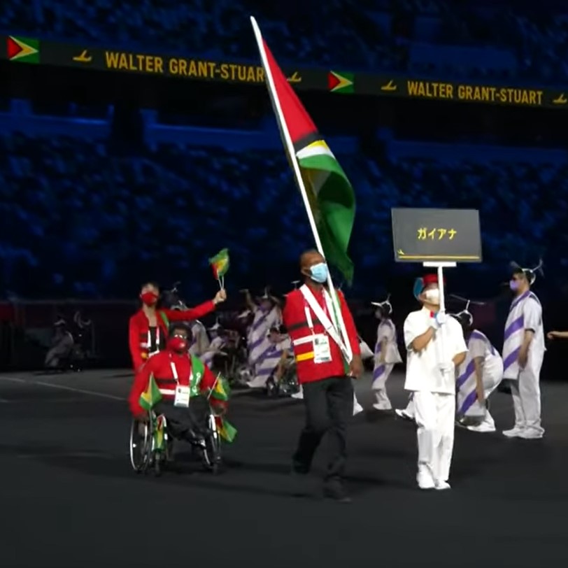 Walter Grant-Stuart carries the Golden Arrowhead at the opening of the Tokyo 2020 Paralympics.