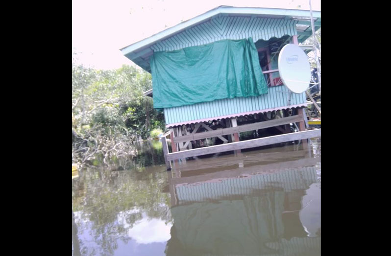 A house under water in Region Ten (Deron Adams photo)