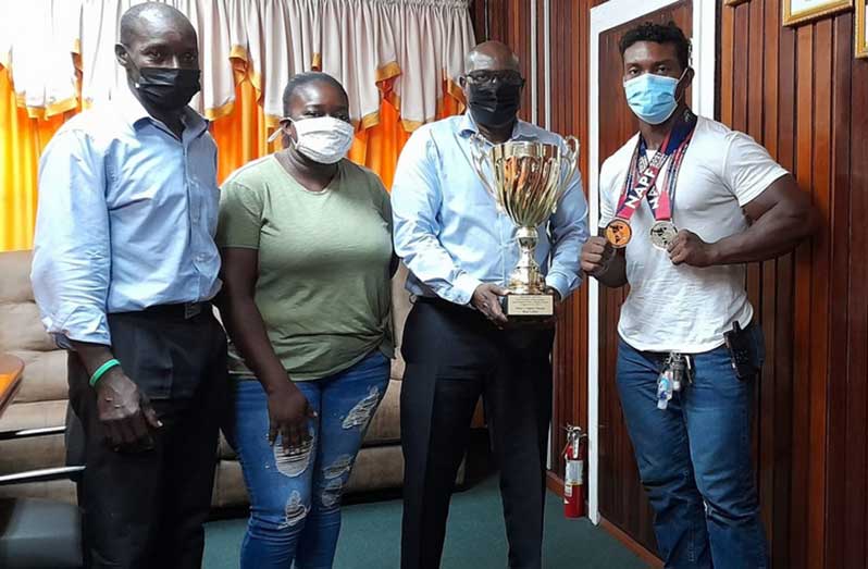 Ninvalle (second from right) poses with the two-time gold medallist (R), the Guyana Powerlifting and Fitness Federation executive member Franklyn Brisport (left) and Nicona Pettersen, Griffith's manager