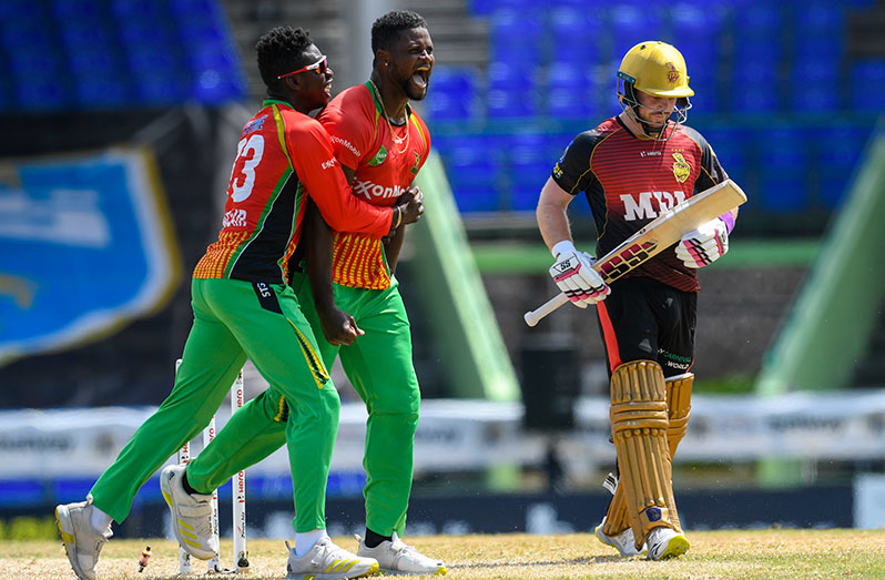 Romario Shepherd (2L) and Kevin Sinclair (L) of Guyana Amazon Warriors celebrate winning against Tim Seifert (R) of Trinbago Knight Riders in the super over during the 2021 Hero Caribbean Premier League match 11 between Trinbago Knight Riders and Guyana Amazon Warriors at Warner Park Sporting Complex on September 1, 2021 in Basseterre, Saint Kitts and Nevis. (Photo by Randy Brooks - CPL T20/Getty Images)
