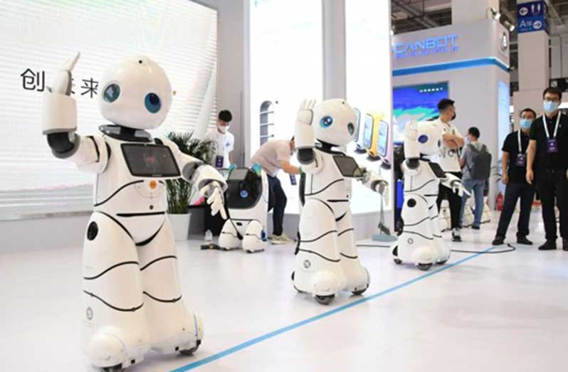 Service robots dance during the World Robot Expo in Beijing, capital of China, Sept. 10, 2021. (Xinhua/Ren Chao)