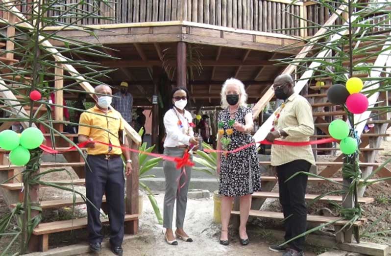 Minister of Tourism, Industry and Commerce, Oneidge Walrond, cuts the ceremonial ribbon to officially commission the eco-lodge (DPI photo)