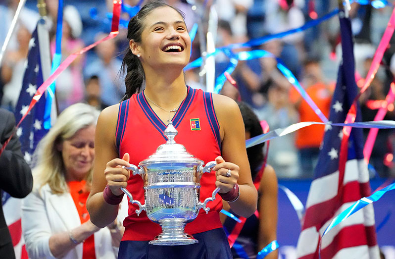 Flushing, NY, USA; Emma Raducanu of Great Britain celebrates with the championship trophy after her match against Leylah Fernandez of Canada (not pictured) in the women's singles final on day thirteen of the 2021 U.S. Open tennis tournament at USTA Billie Jean King National Tennis Center. Mandatory Credit: Robert Deutsch-USA TODAY Sports.