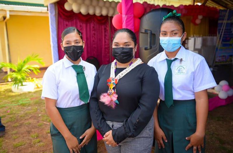 First Lady, Mrs. Arya Ali, poses with two students of the St. Ignatius Secondary School