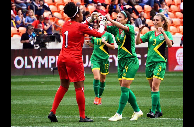 FLASHBACK: Guyana’s Chantel Sandiford is congratulated by sisters Kayla and Briana De Souza after pulling off a great save in their 2-1 win over Guatemala at the BBVA Compass Stadium in Houston, Texas.