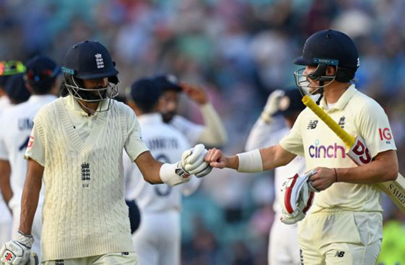 Haseeb Hameed and Rory Burns punch gloves after an unbeaten 77-run stand on day four, England vs India, 4th Test, The Oval, London, 4th day, September 5, 2021 © AFP/Getty Images